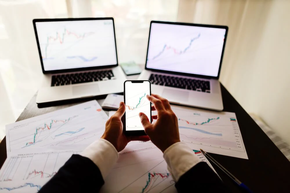 Forex trader reviewing charts and focusing on controllable trading decisions rather than market direction