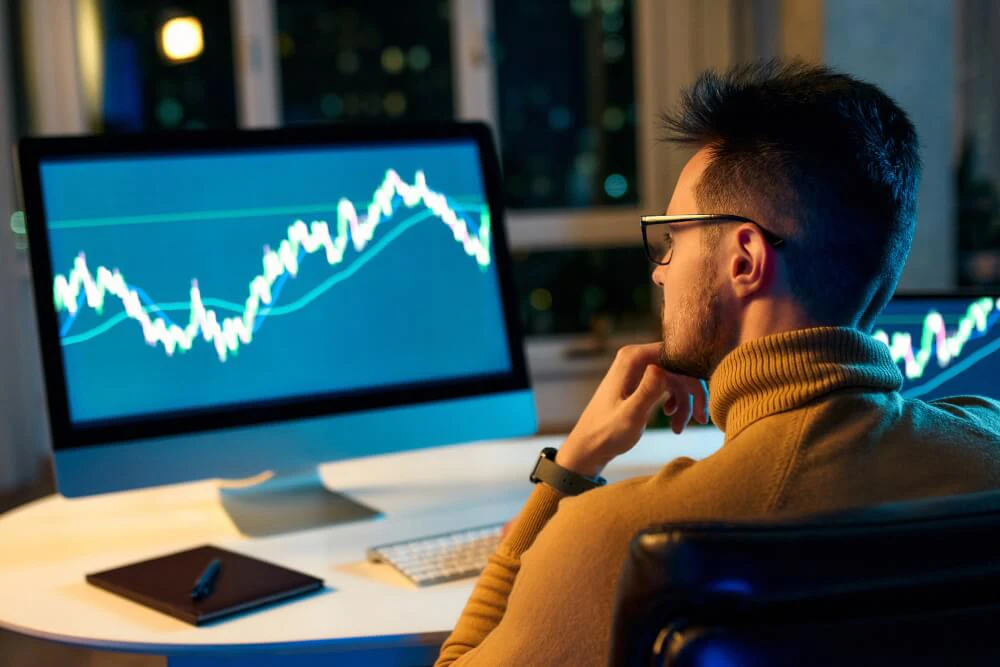 Trader managing leveraged positions while monitoring market conditions and risk exposure