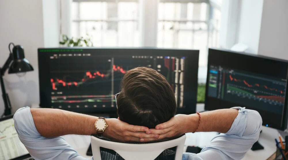 Trader stepping away from screens to stay disciplined and avoid chasing trades after strong market moves