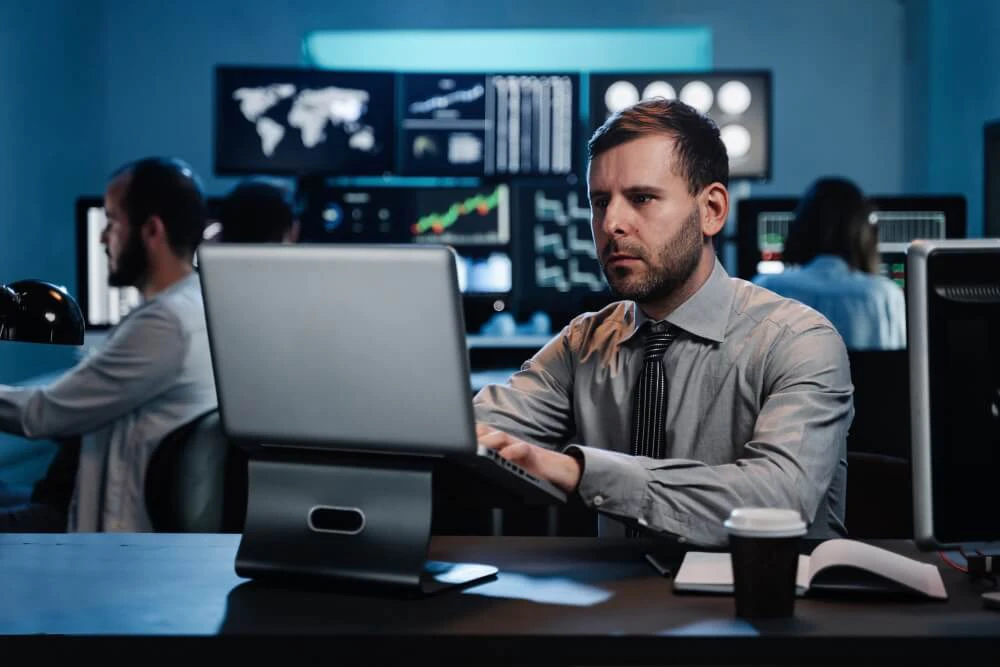 Trader watching markets during speculative pressure on currency peg