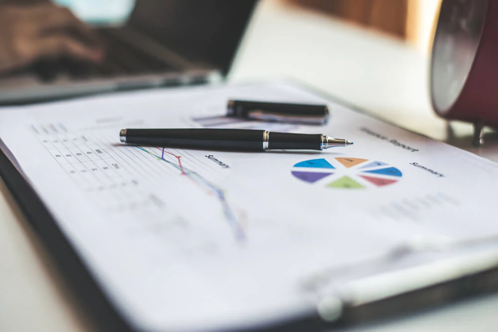 Trader reviewing charts and performance data to evaluate trading process rather than profit and loss