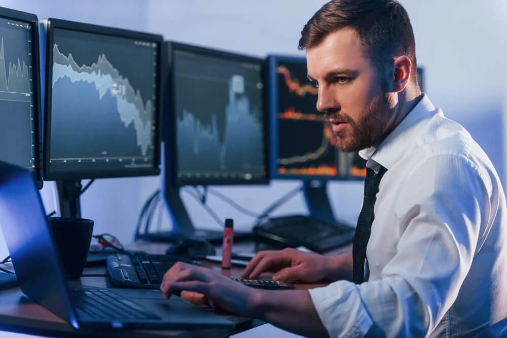 Trader staying calm and focused after profits while reviewing charts and trading plan