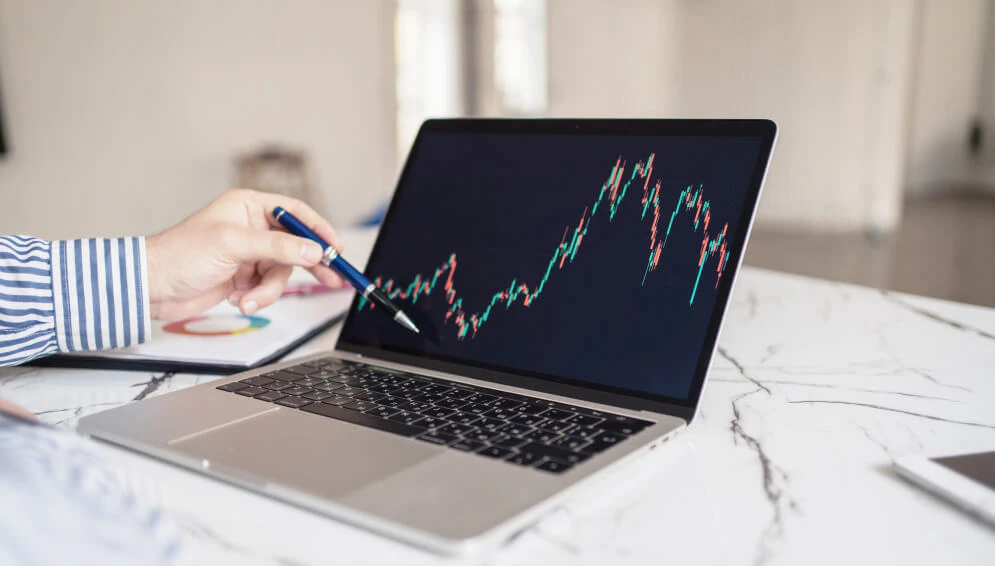 Trader reviewing trade history and analyzing performance using charts and notes